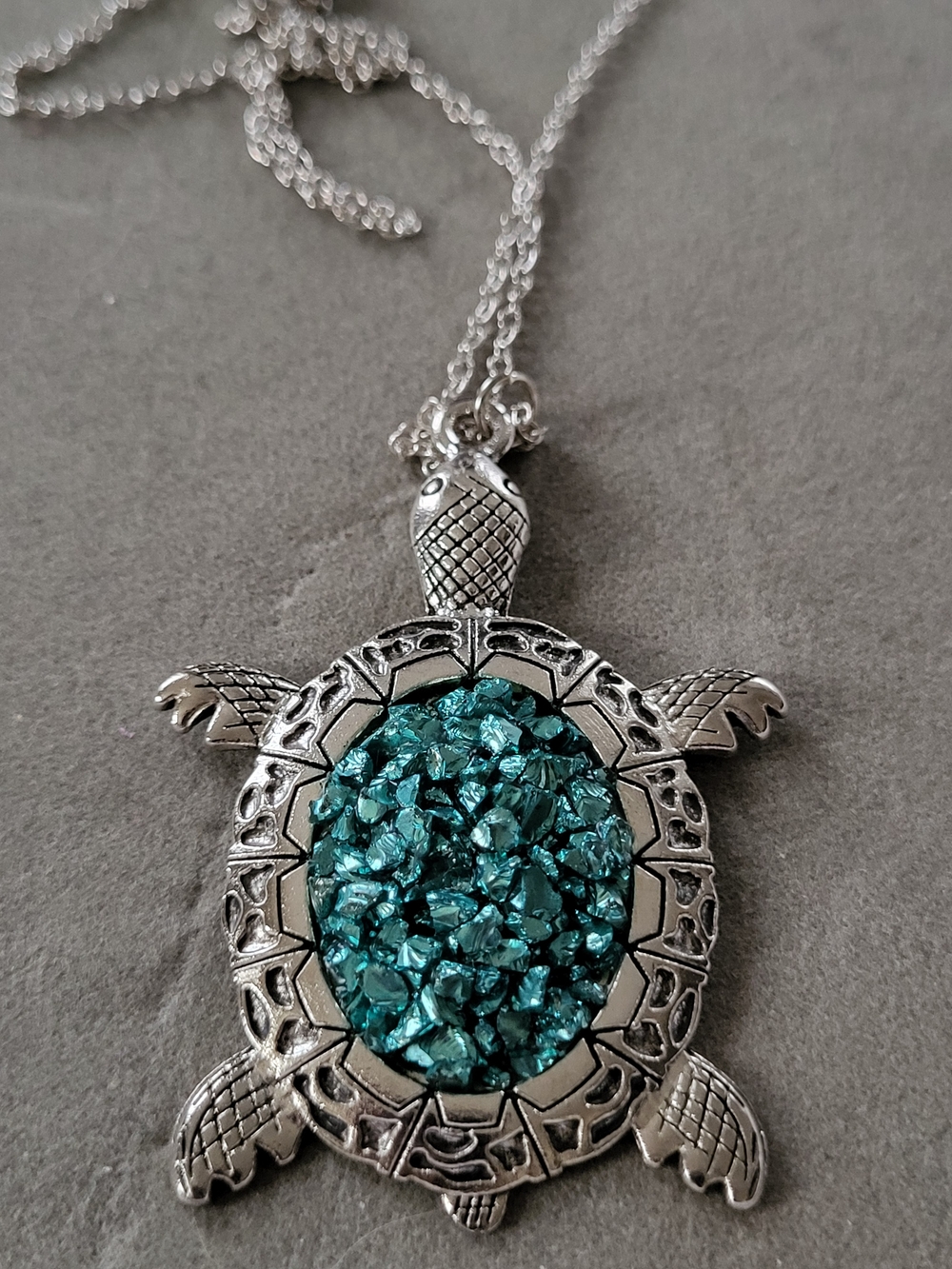 Silver Toned Turtle Necklace with Teal Crystal Center